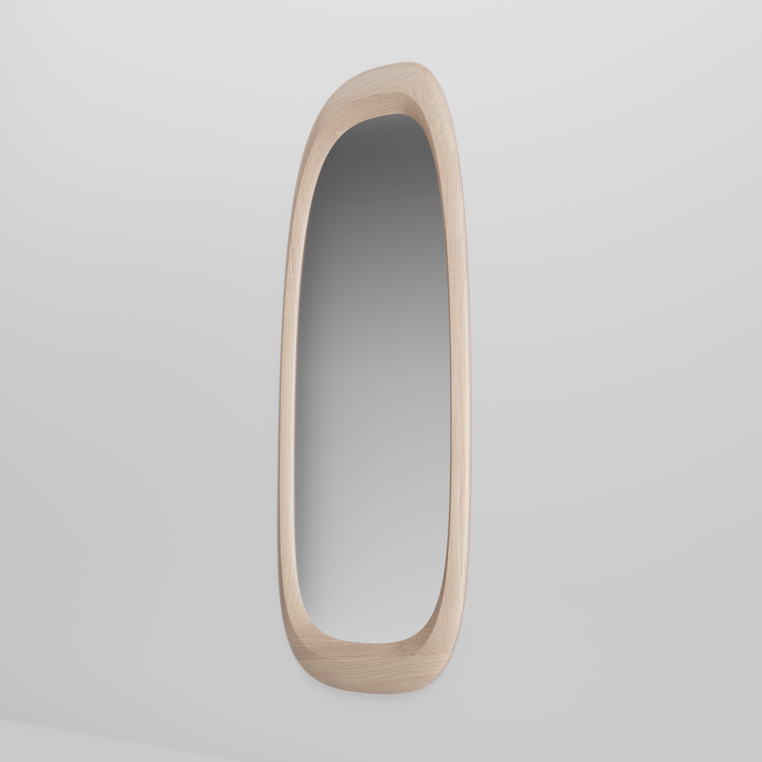 Three-quarter view of the Monument Mirror highlighting its contoured wooden frame and precise craftsmanship.