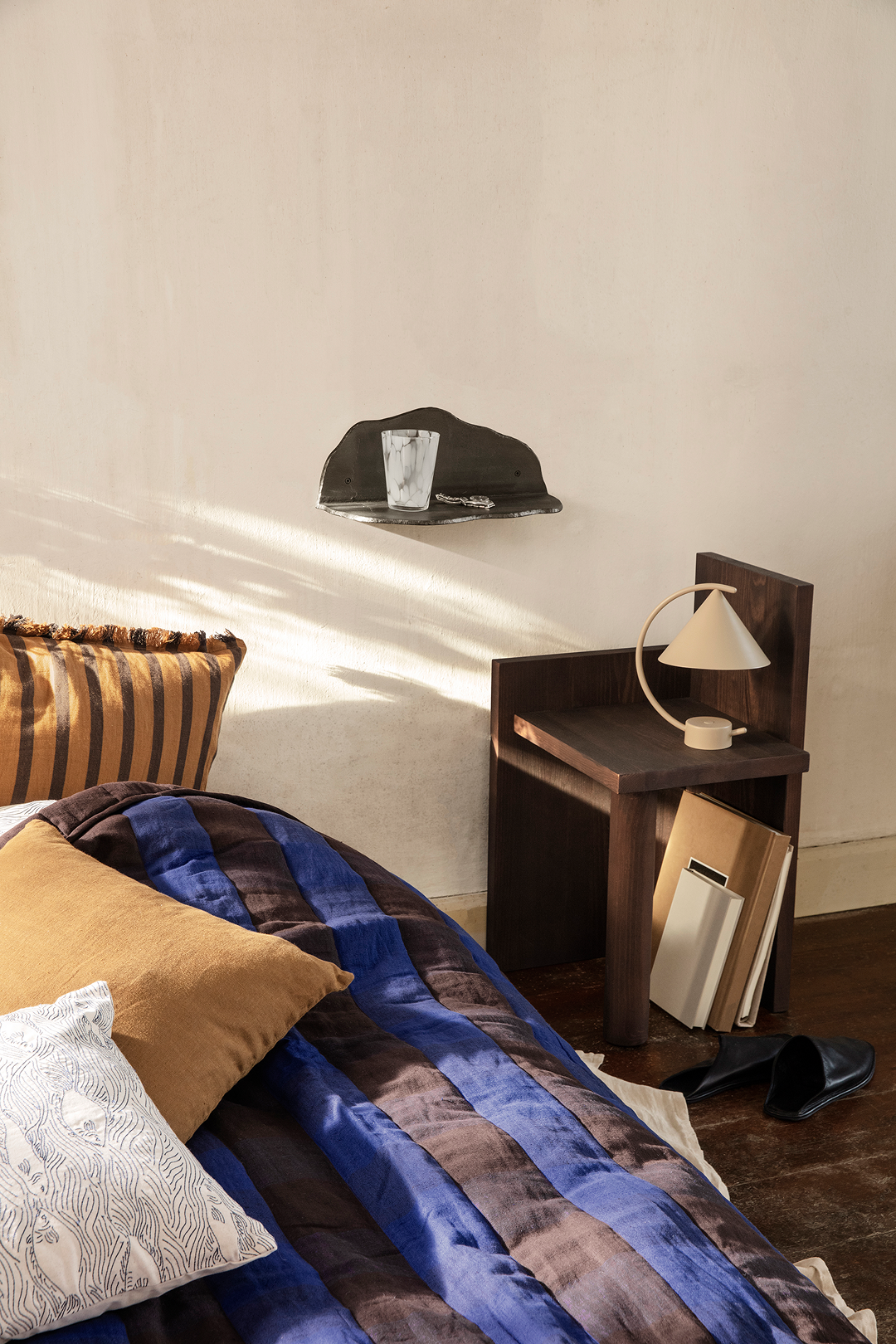 Meridian table lamp by Ferm Living, designed with clean geometric shapes and a movable mechanism for adjustable sculptural lighting effects.