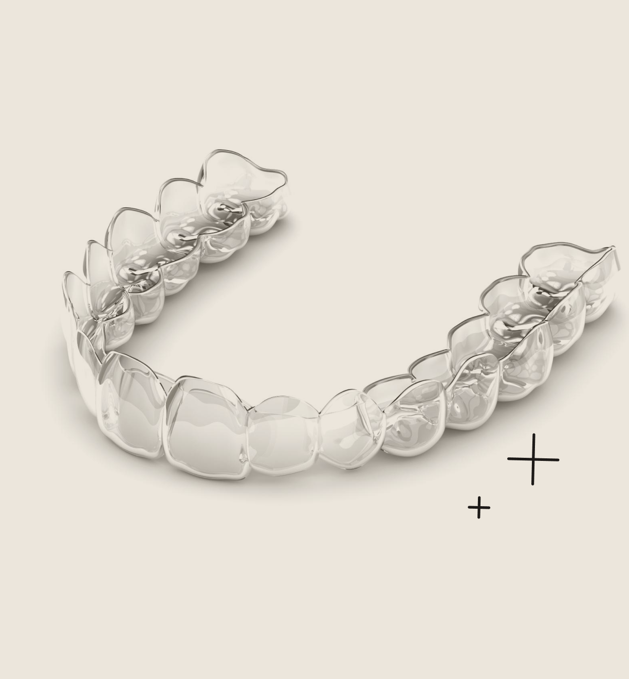 A clear orthodontic dental aligner resting on a light-colored background.