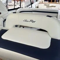Close-up of a custom boat seat fabricated by Robie Canvas with the brand name 'Sea Ray' embroidered on it.