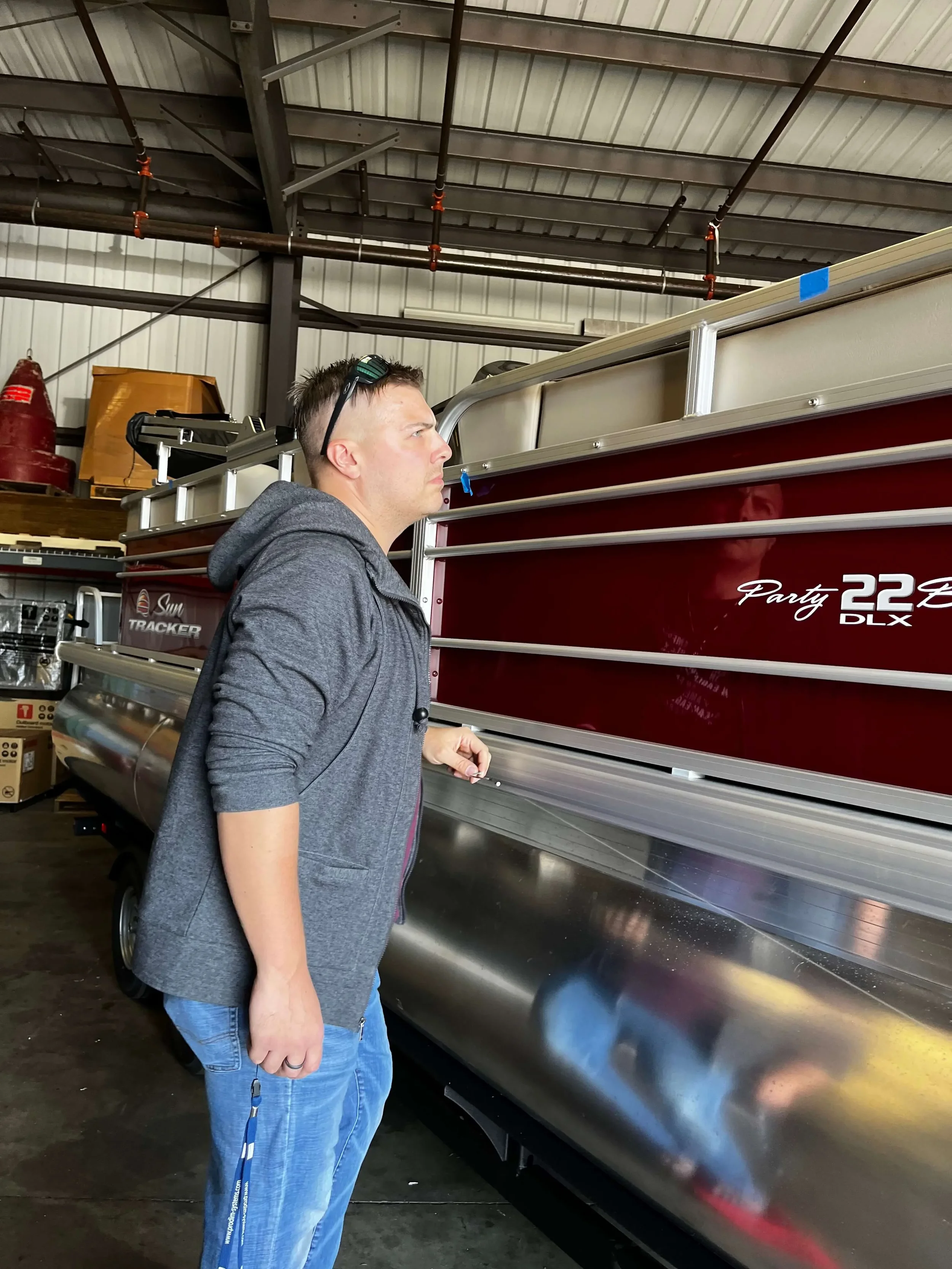 A Robie Canvas employee carefully checking the pattern lines for the design of a custom pontoon boat mooring cover.