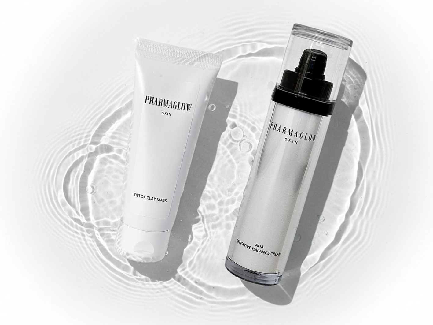 Skincare products on a reflective surface with water ripples, including a detox clay mask and a sensitive balance cream from Pharmaglow Skin.