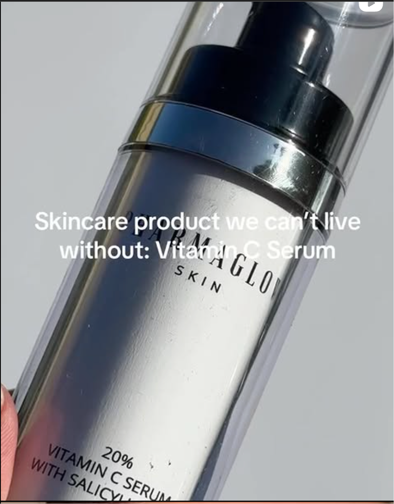 A skincare product in a clear bottle with a pump dispenser, labeled 'Vitaglo Skin Vitamin C Serum', with text overlaid that says 'Skincare product we can't live without: Vitamin C Serum'.