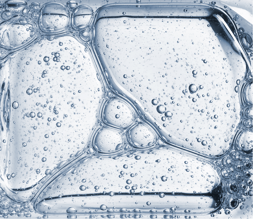 Close-up of ice cubes in carbonated water with bubbles
