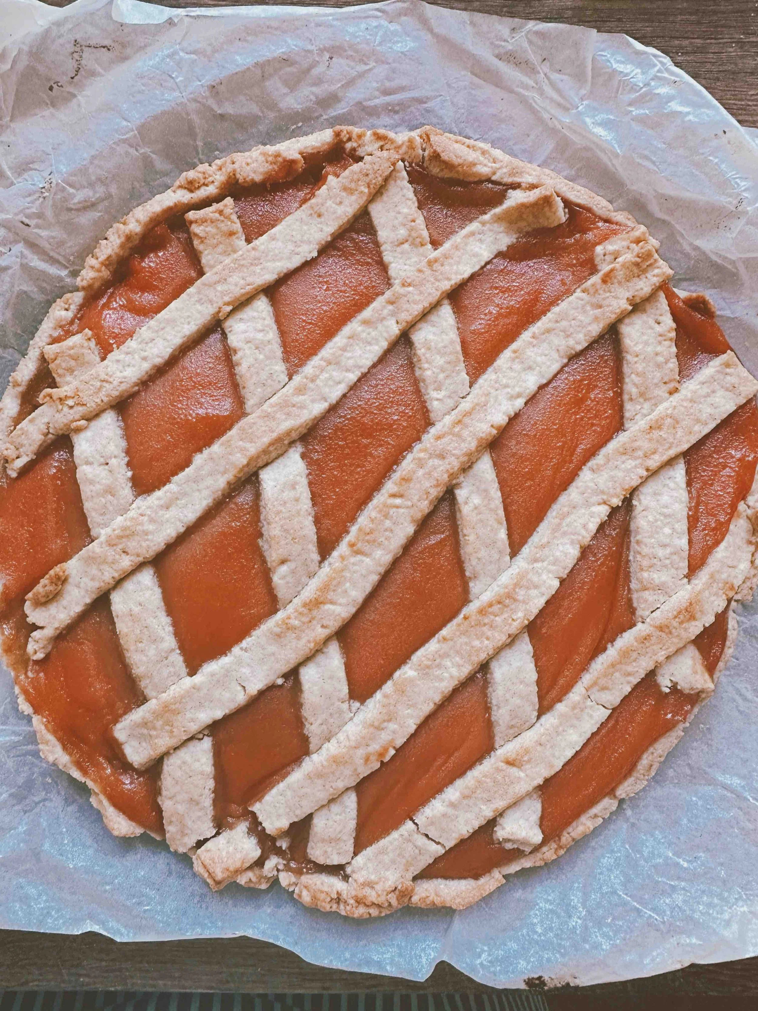 Homemade tart with organic quince marmalade on parchment paper