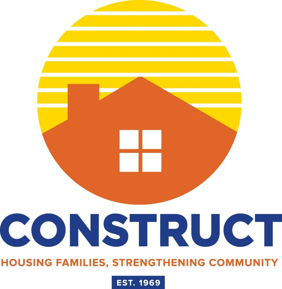 A logo featuring a stylized house with a chimney and four windows, set against a yellow sun with horizontal stripes. Below, the word "CONSTRUCT" is written in large blue letters, with the tagline "Housing families, strengthening community," and an establishment date of 1969.