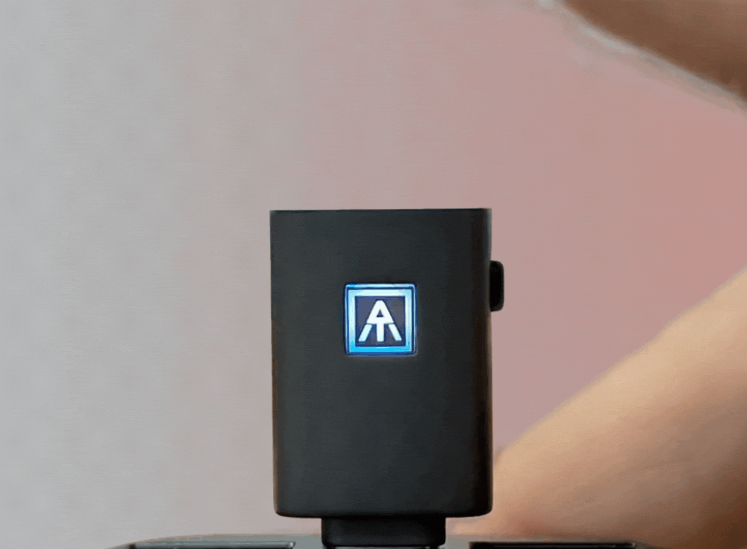 Close-up of a ATKey.Pro getting tapped and lighting green.