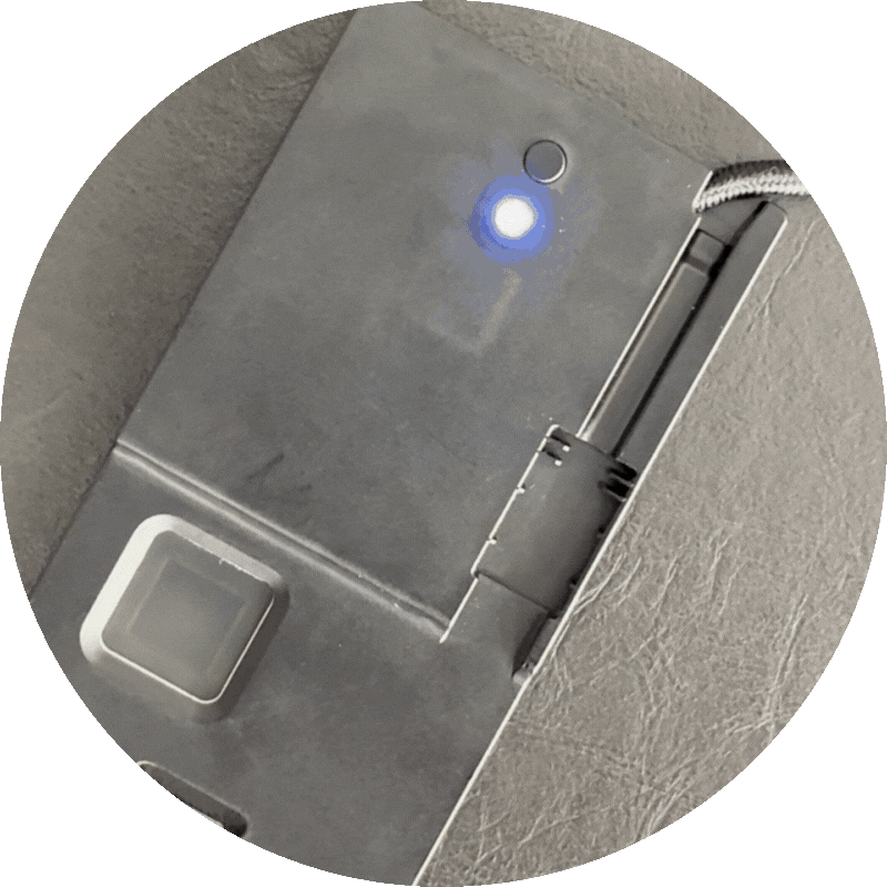 Close-up of an ATKey.Badge plugged in. The LED is flashing white requiring the user to press the physical button on the back.