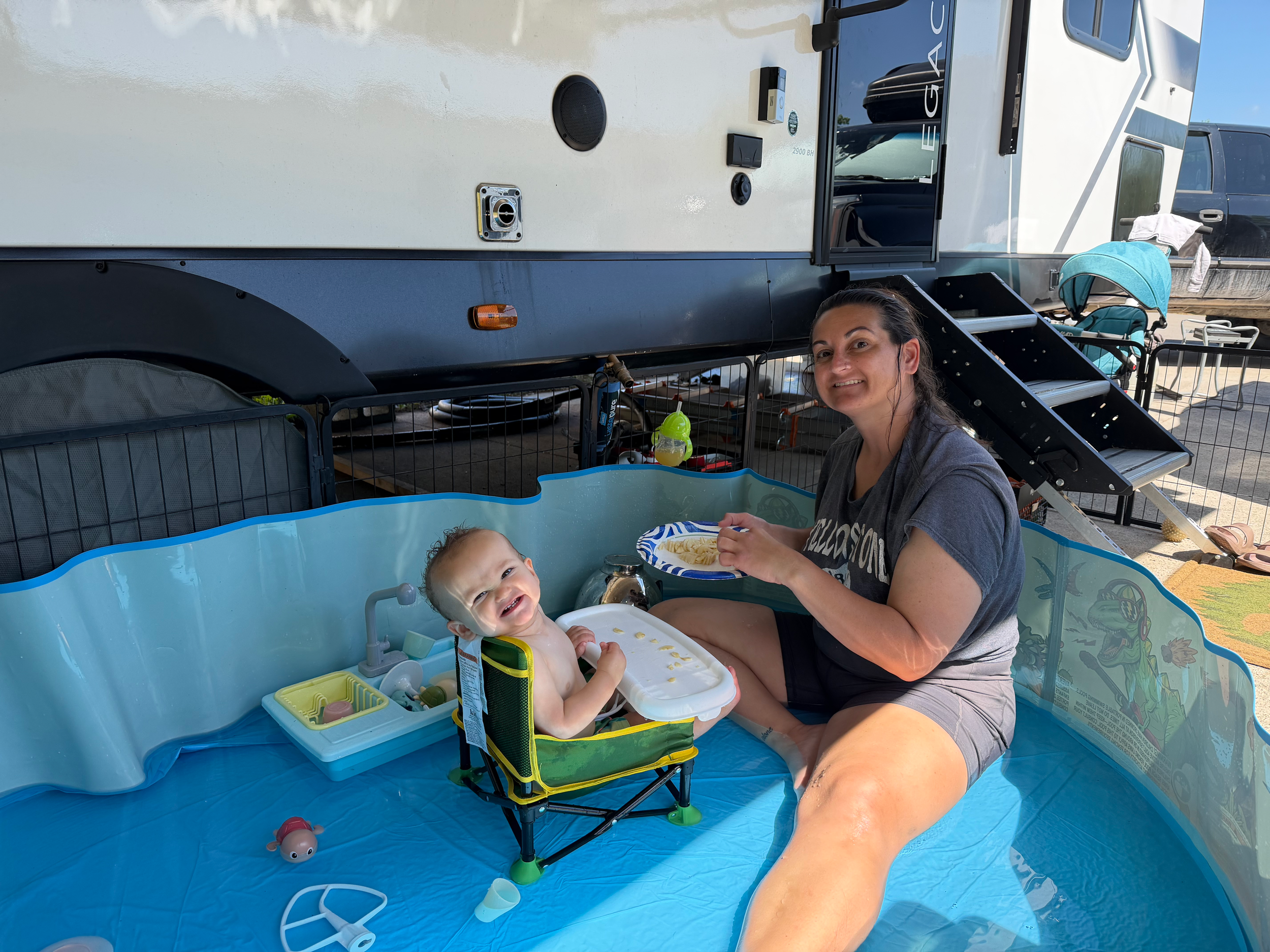 Mom and toddler enjoying an ordinary summer day outside their travel trailer while living full-time in an RV in Tennessee.