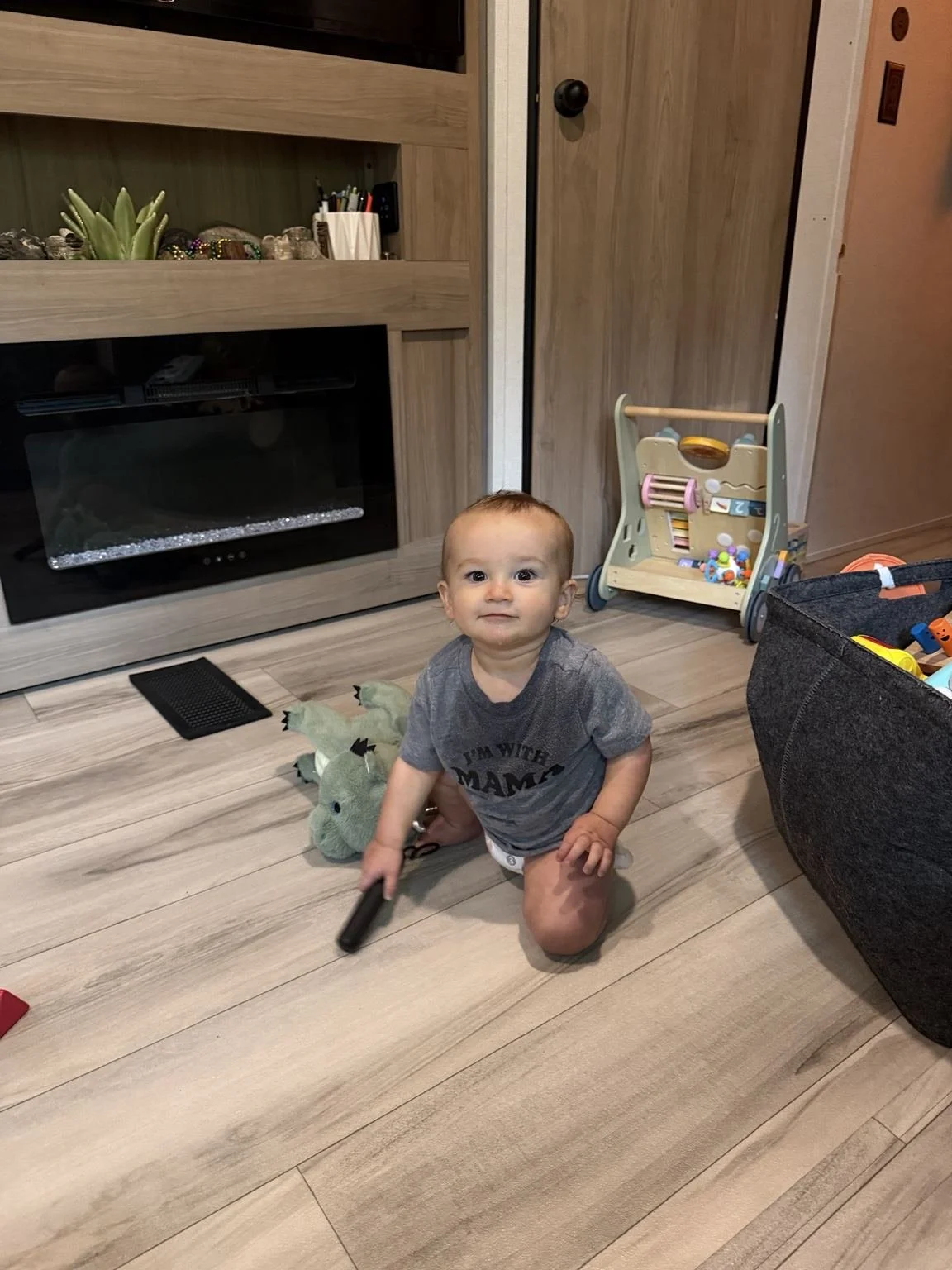 Toddler playing with his toys on the floor inside the family's travel trailer at Lake Norman.