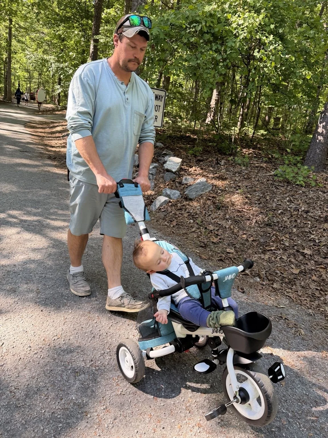 Banks sleeping in his tricycle during a family walk through Devils Fork State Park in South Carolina.