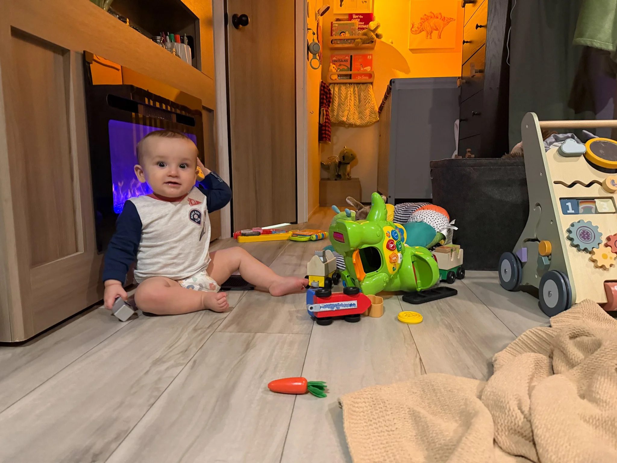 Baby playing on the floor inside an RV during everyday life raising a baby on the road
