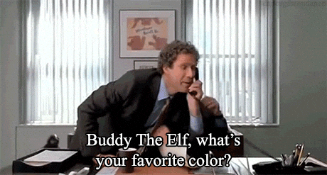A man in a suit sitting at a desk, talking on the phone, with text saying, 'Buddy The Elf, what's your favorite color?'