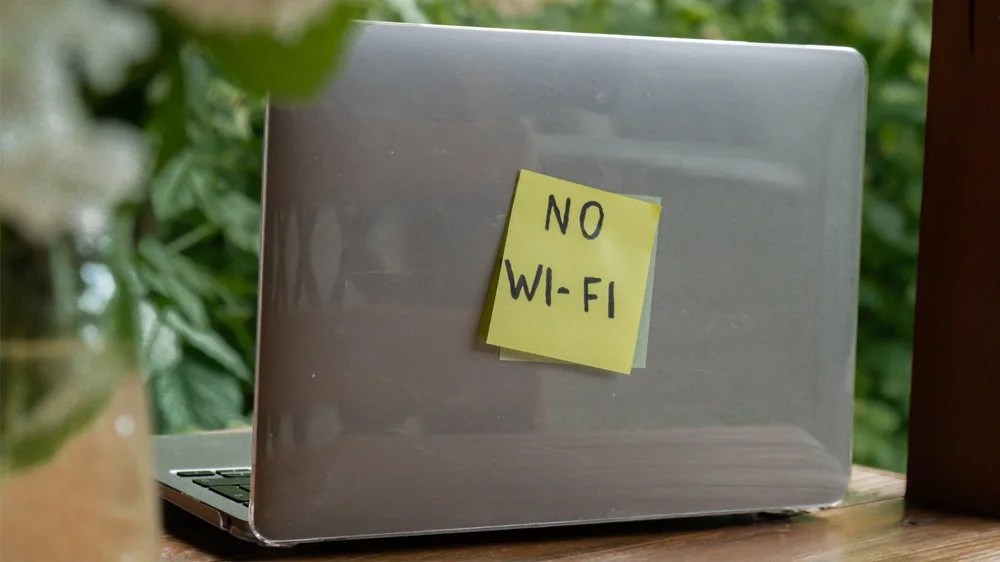 Laptop with 'no wifi' sticker on it
