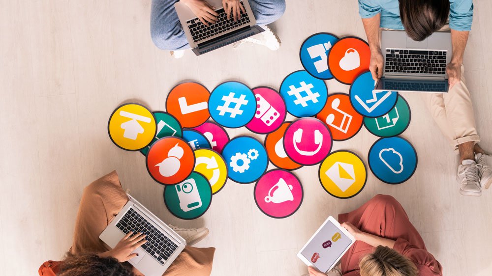 People sharing videos from an online conference on their laptops