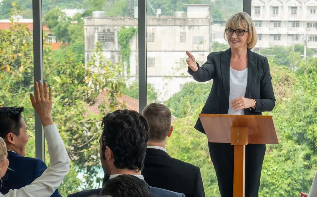 Hybrid corporate event with leadership speaking to both in-room and remote audiences