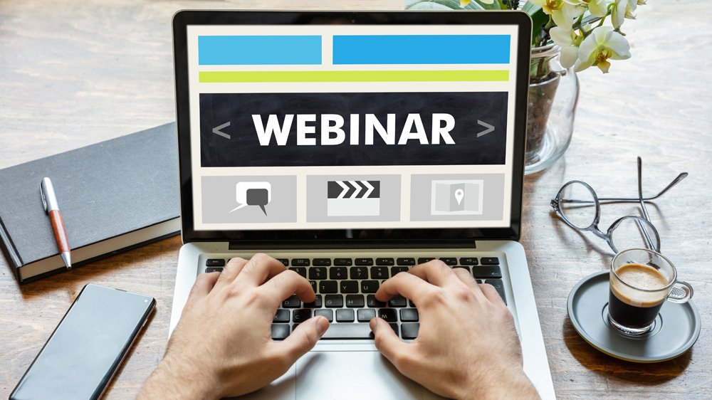 'WEBINAR' text on a laptop screen