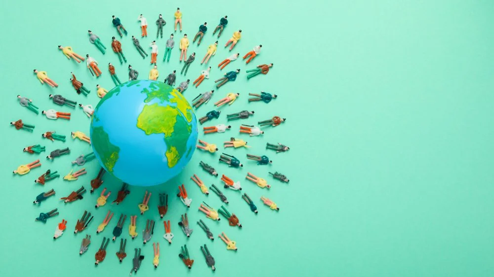 Globe with people around it