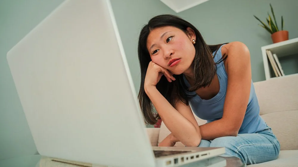 Bored woman looking at a laptop