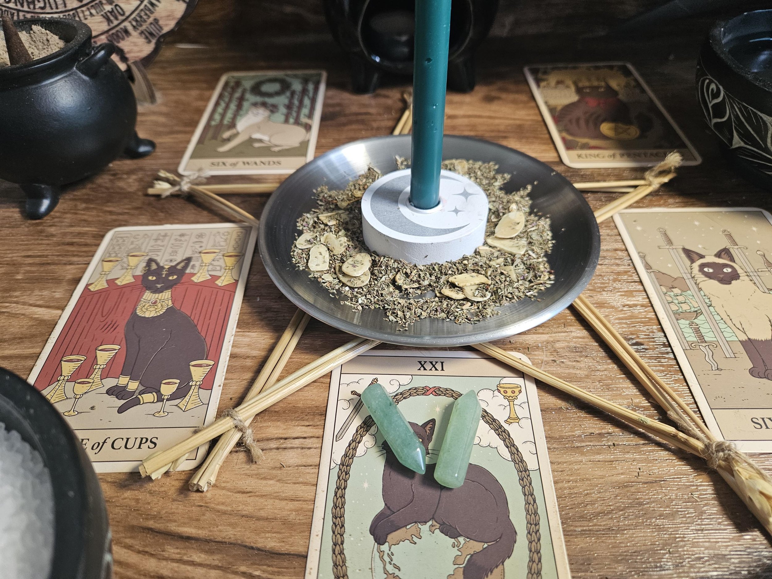 Citrine crystal pendant on an altar with beeswax candles, spices, and burning incense. (Copy)