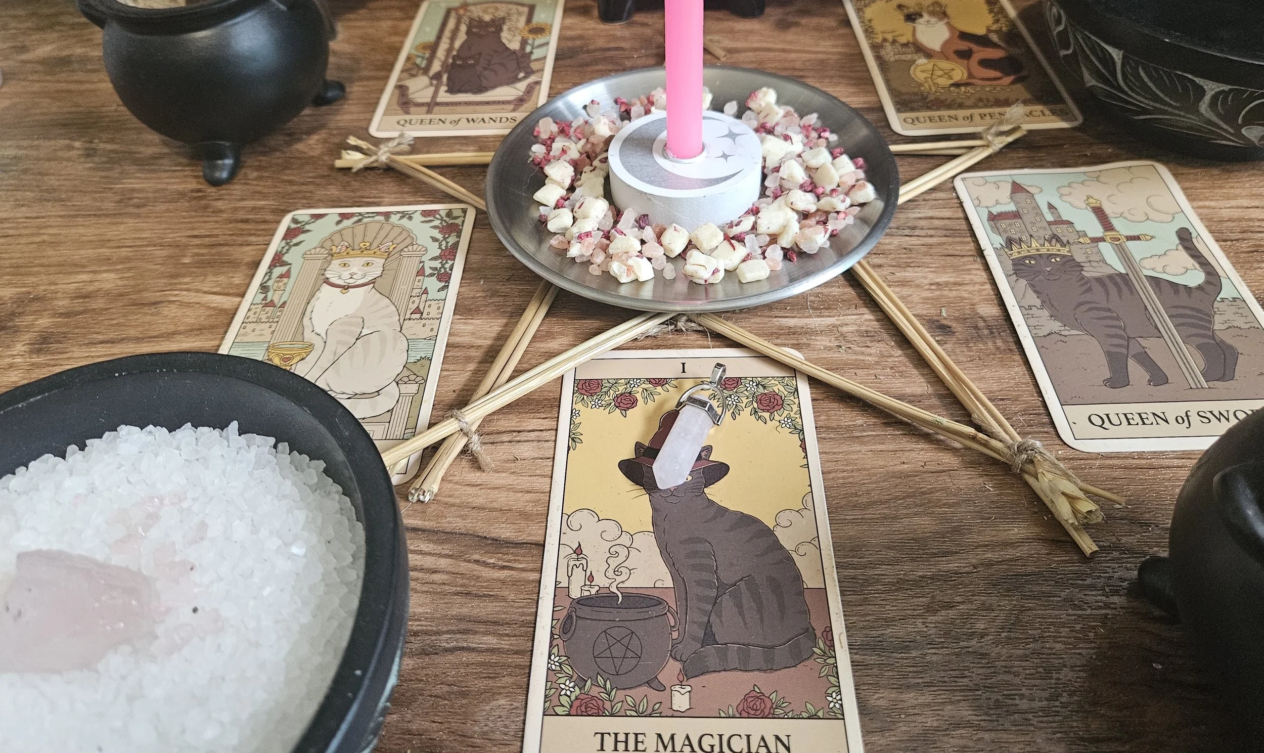A table set with tarot cards, lit candles, and a small bowl of salt, creating a mystical atmosphere for a reading.