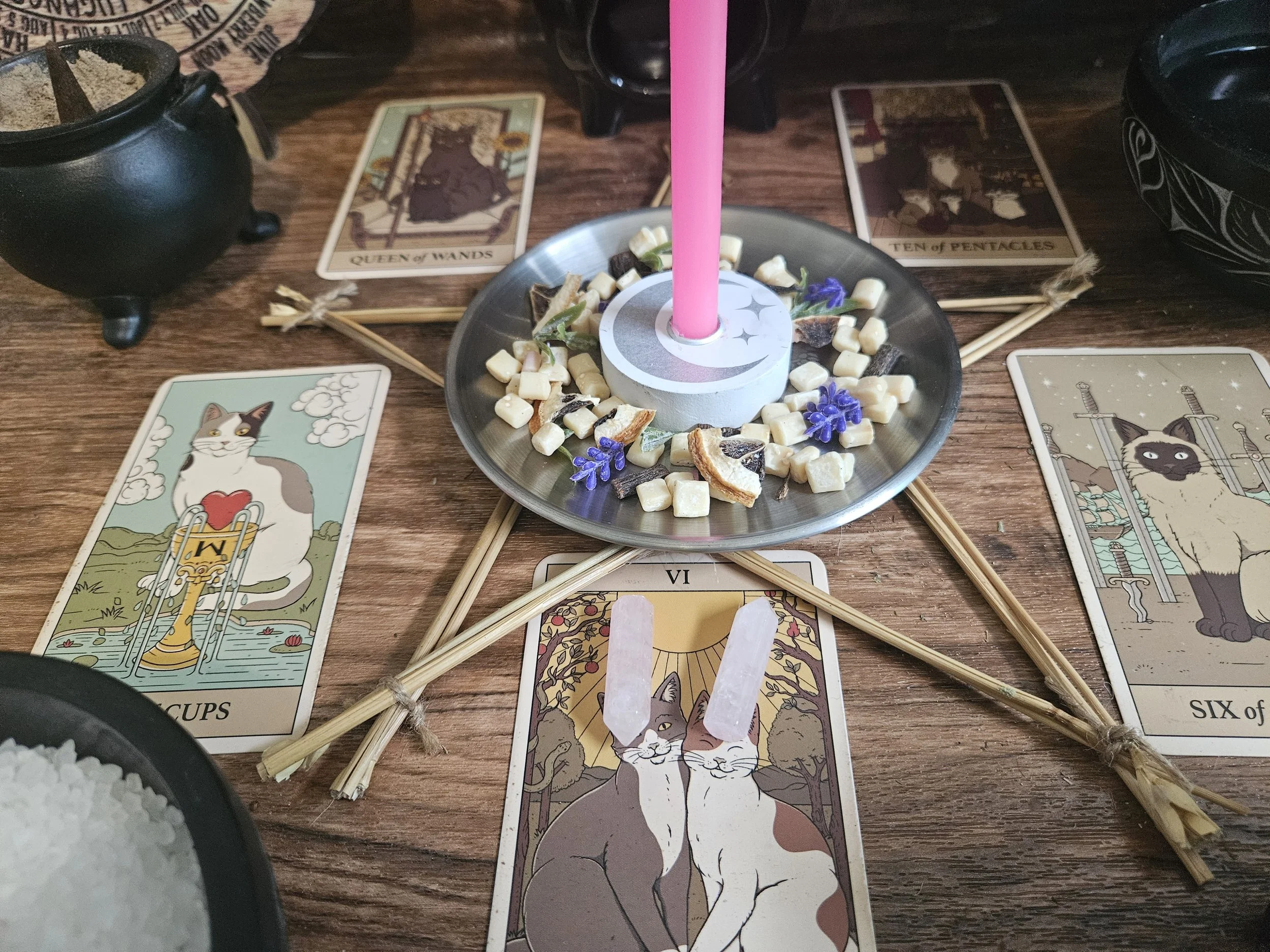 A close-up of the optional upgrade amulet featuring a small, polished pink rose quartz crystal tower pendant for the Forgiveness and Reconciliation Spell.