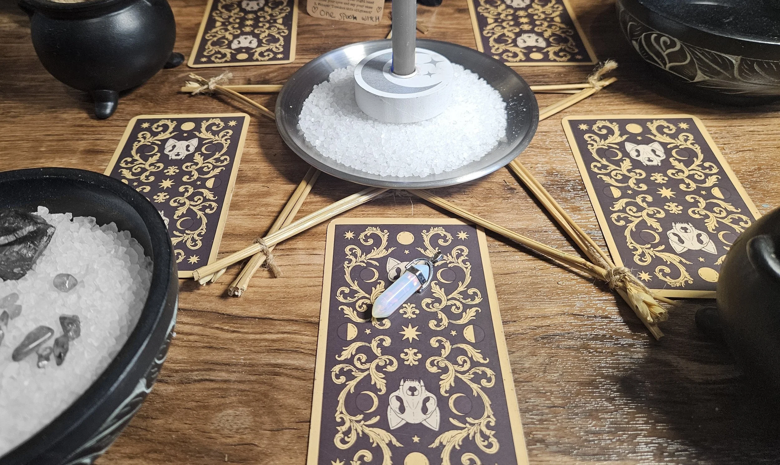 A close-up image of a small, polished rainbow moonstone crystal tower charm upgrade option for the custom multi-spell combination ritual.