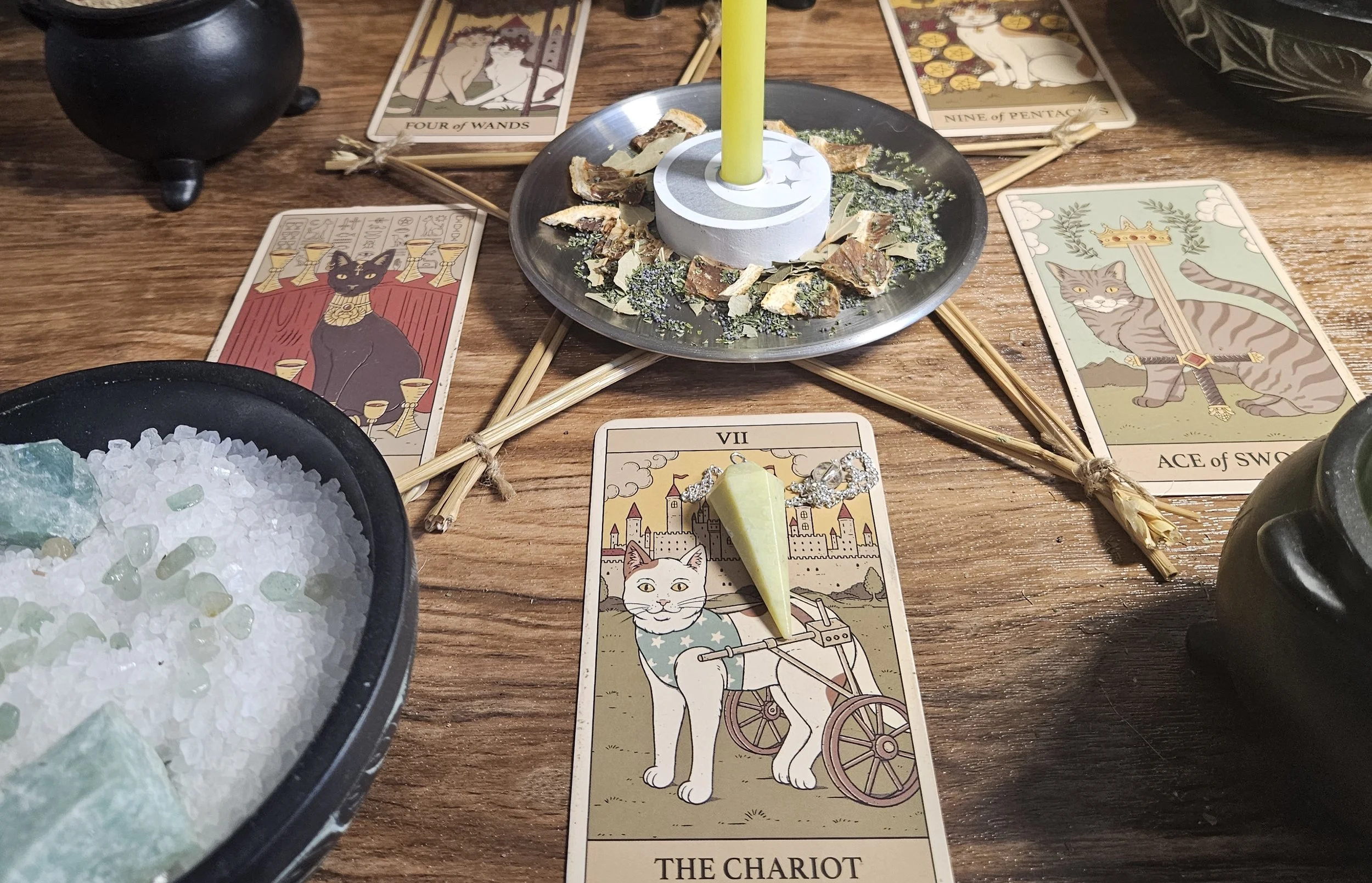 A collection of colorful good luck amulets displayed on a wooden surface, each featuring unique designs and symbols.