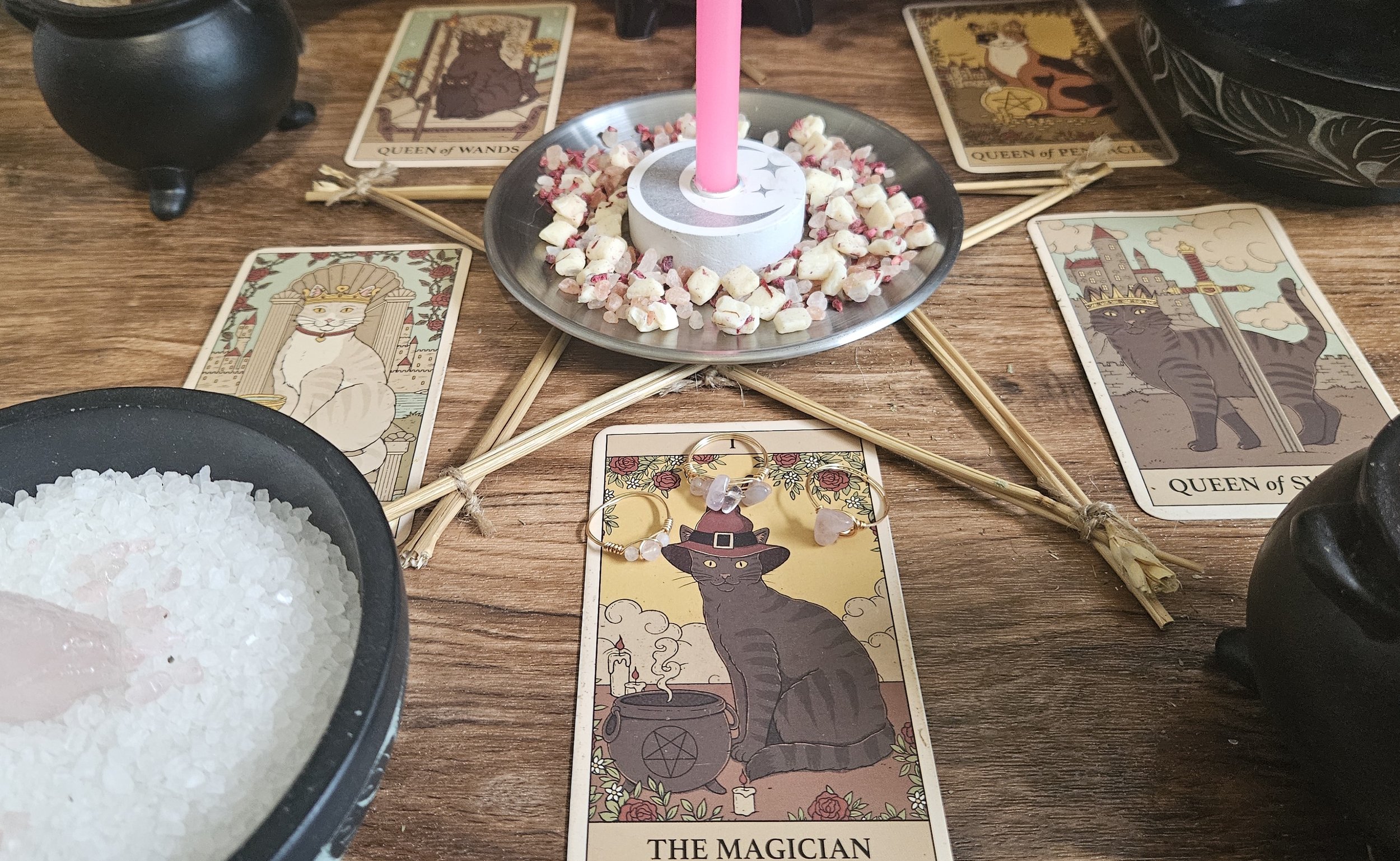 A table displaying tarot cards and lit candles, creating a mystical atmosphere for a reading session.