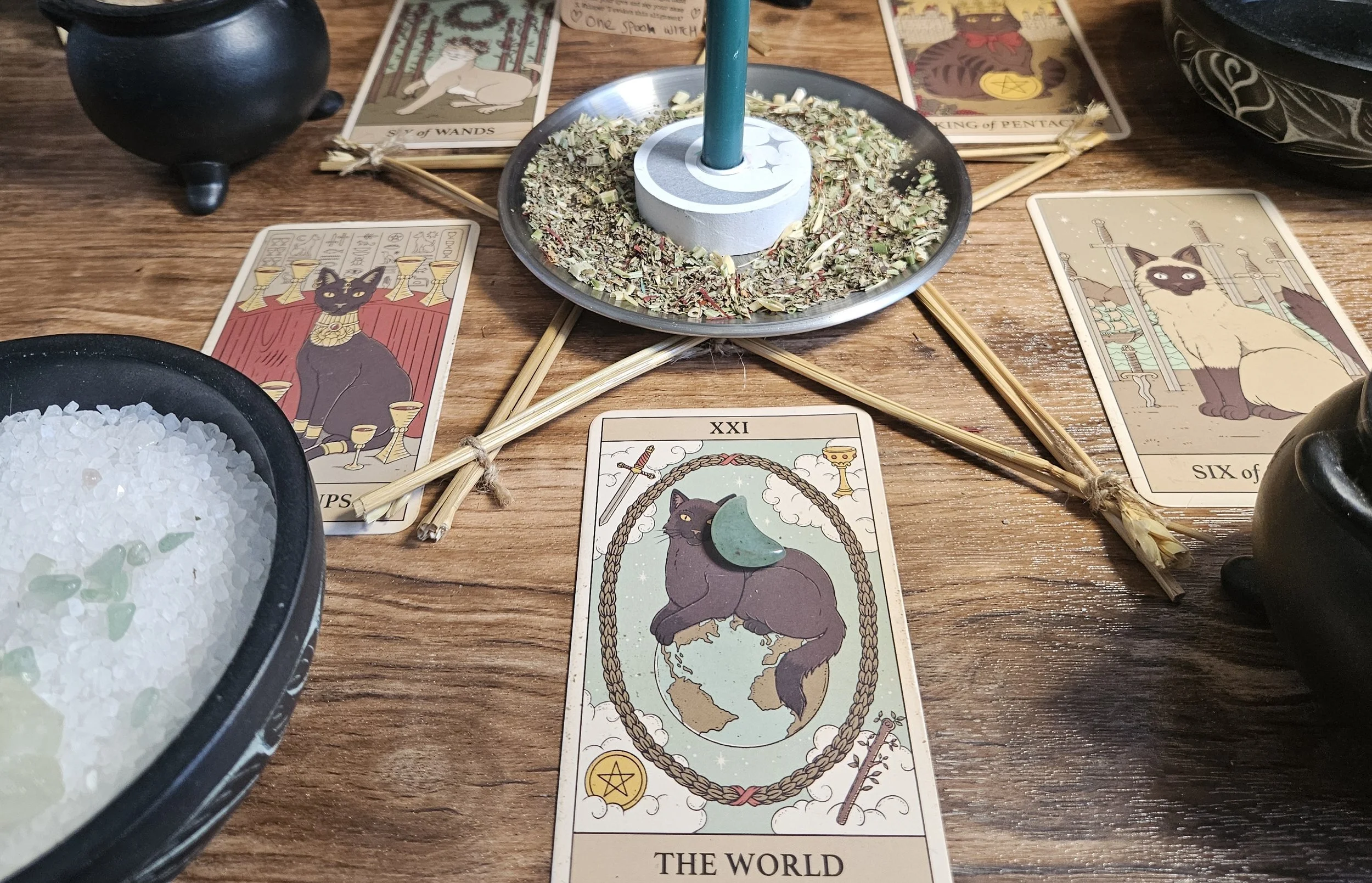 A tarot card spread featuring the World card, symbolizing completion, fulfillment, and global unity in a mystical context.