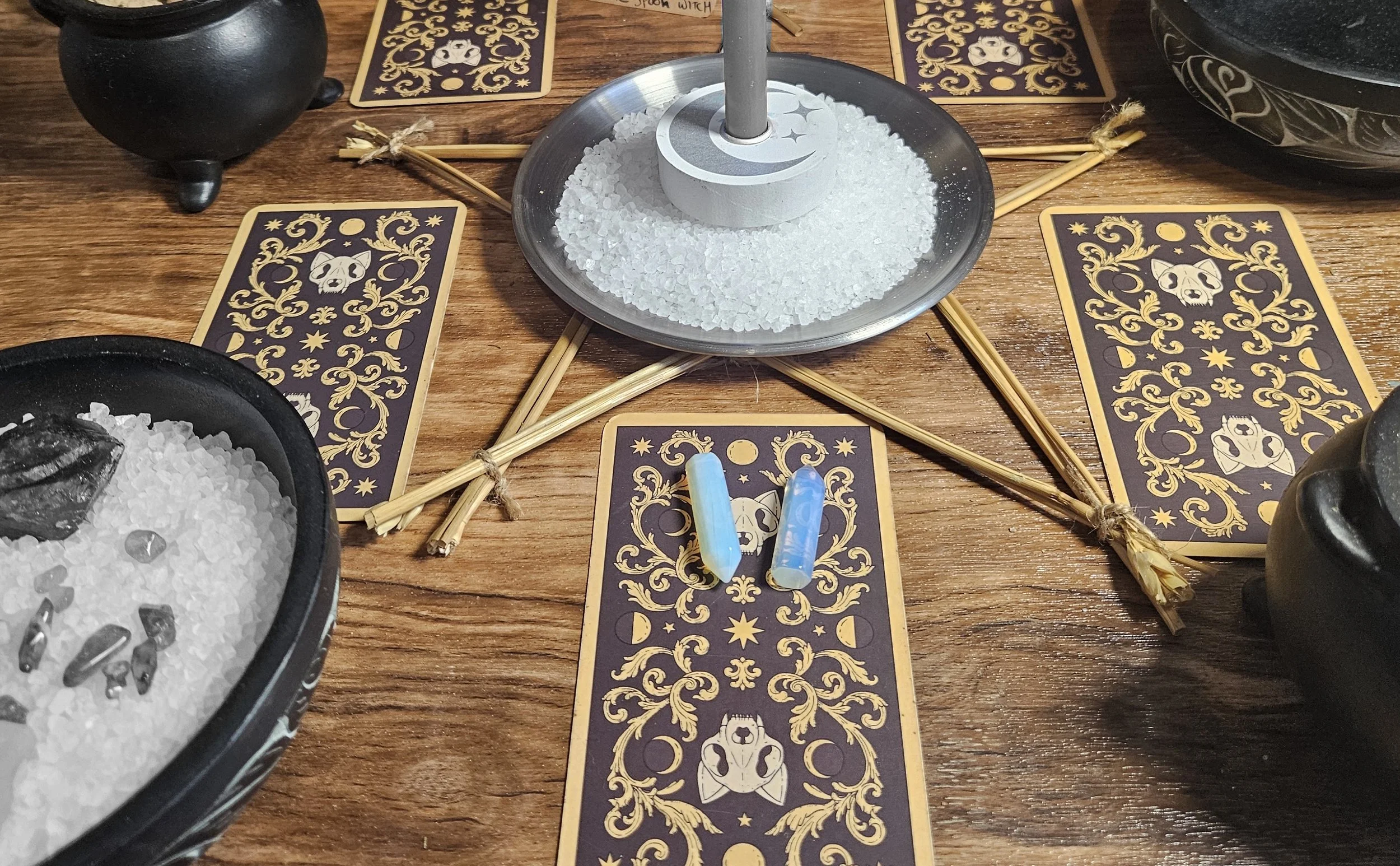 A detailed photograph showcasing the small, polished rainbow moonstone crystal tower pendant option for the custom multi-spell combination ritual.