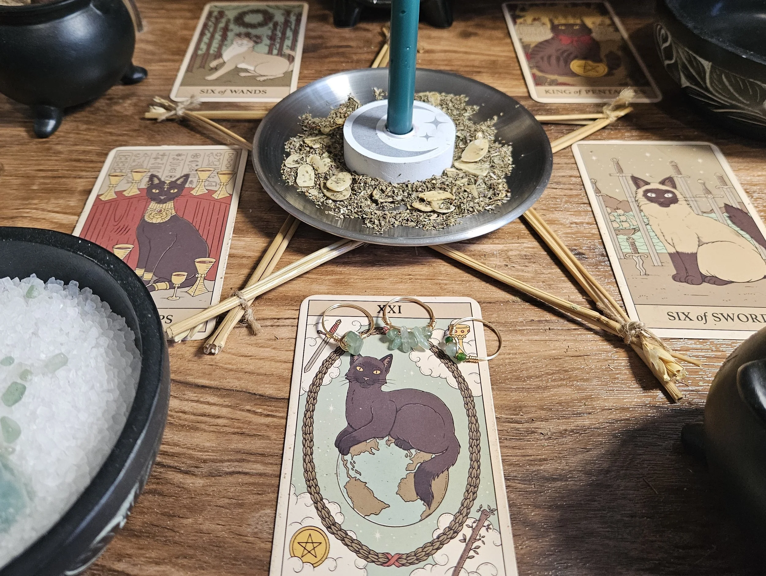 A table displaying tarot cards, crystals, and candles, creating a mystical atmosphere for a tarot reading session.