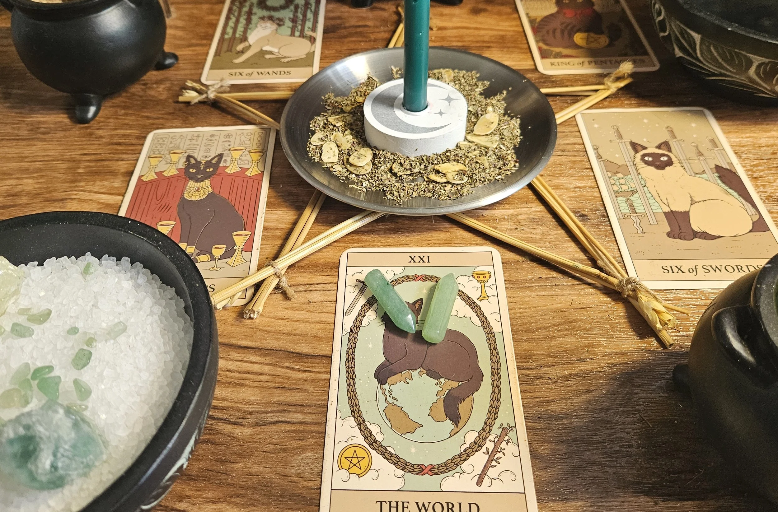 A miniature, flat-bottomed green aventurine crystal tower point resting on a witchcraft altar to act as a permanent pocket battery for money manifestation.