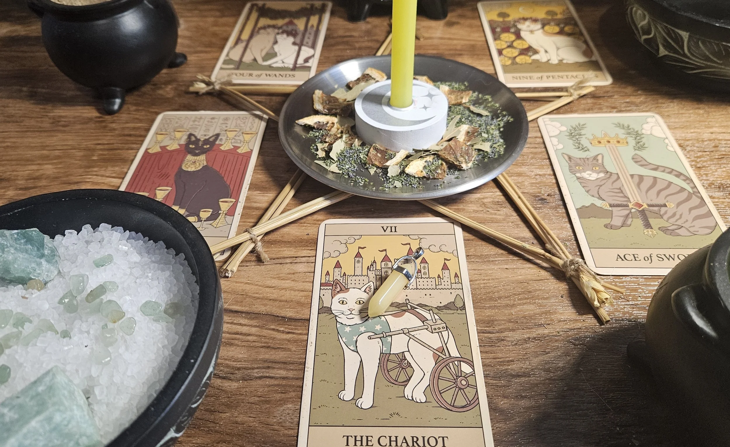 A table displaying tarot cards, crystals, and candles, creating a mystical atmosphere for a tarot reading session.