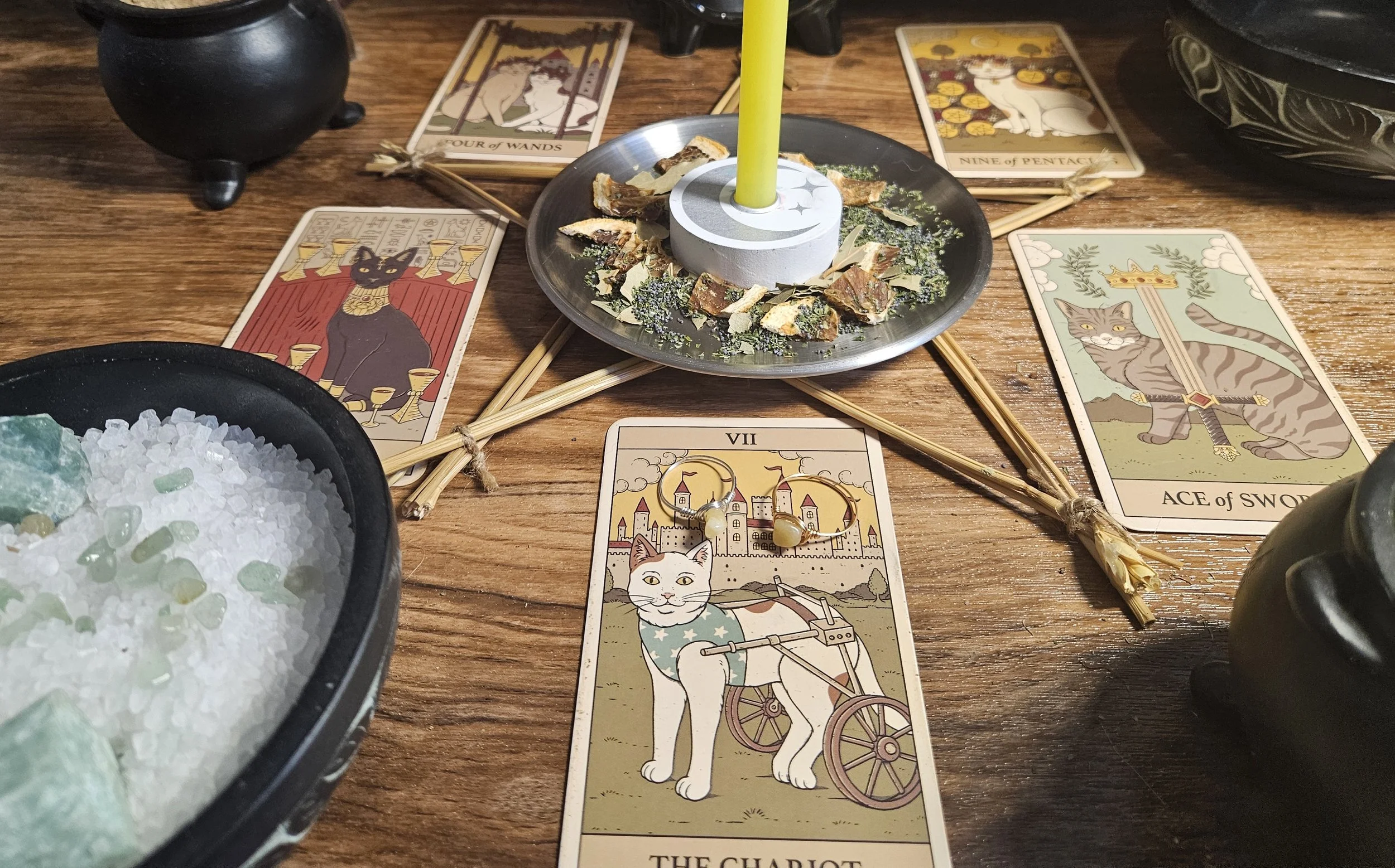 A table displaying tarot cards, crystals, and candles, creating a mystical atmosphere for a tarot reading session.
