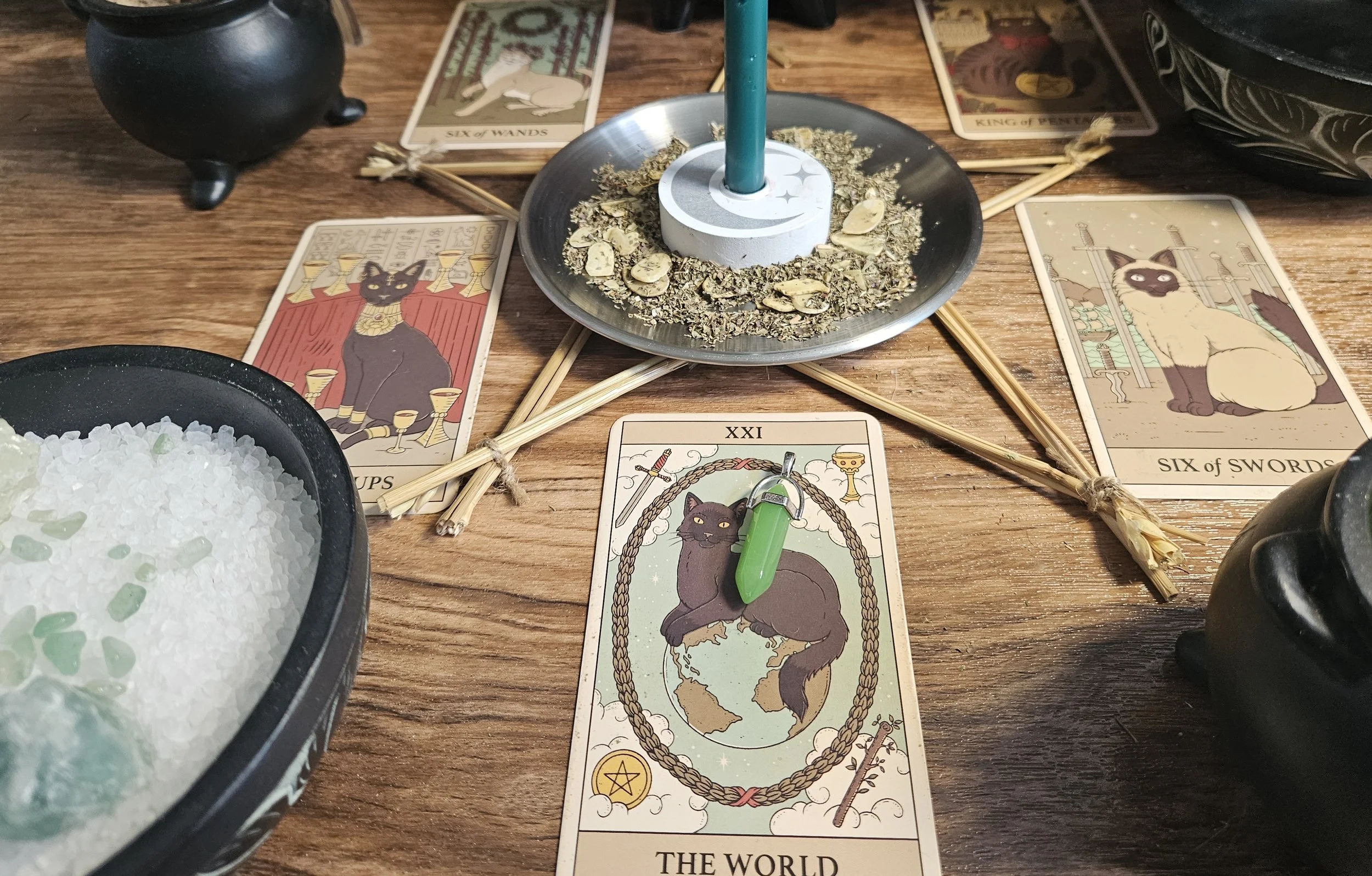 A tabletop set with tarot cards laid out and a glowing candle, suggesting a tarot reading session.