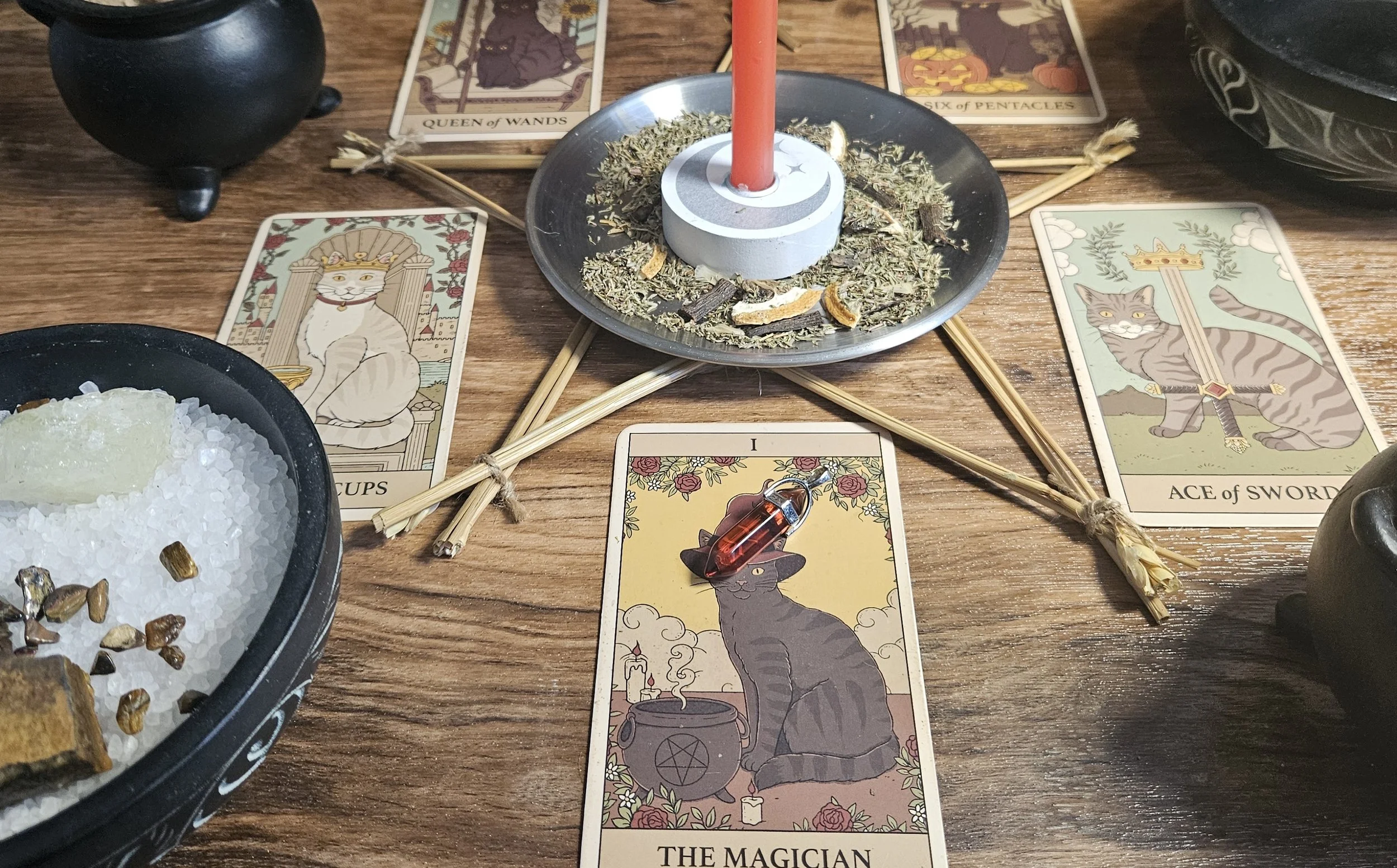 A table displaying tarot cards, crystals, and candles, creating a mystical atmosphere for a tarot reading session.