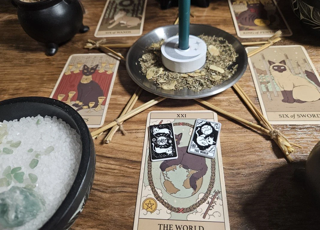 An authentic white magick money drawing and abundance ritual being cast to charge a lucky cat tarot charm prosperity talisman on a live witchcraft altar.