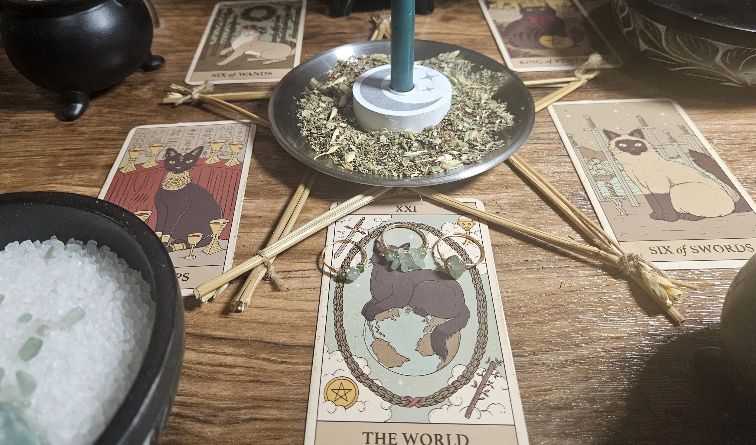 A tarot card deck featuring a candle on top, symbolizing illumination and insight in tarot readings.