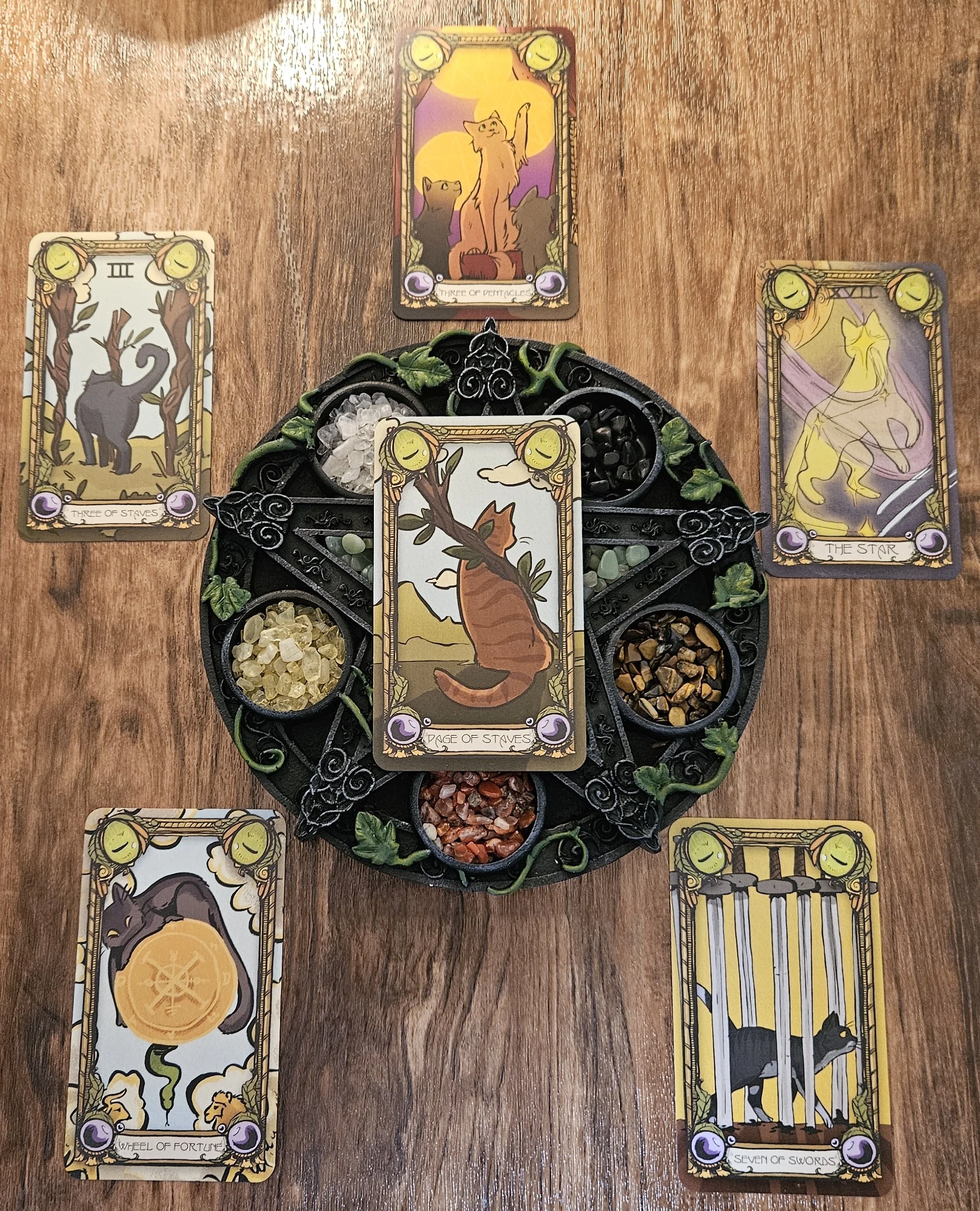 A detailed overhead photo of the soul contract tarot reading layout with all cards flipped over to reveal their illustrated faces.