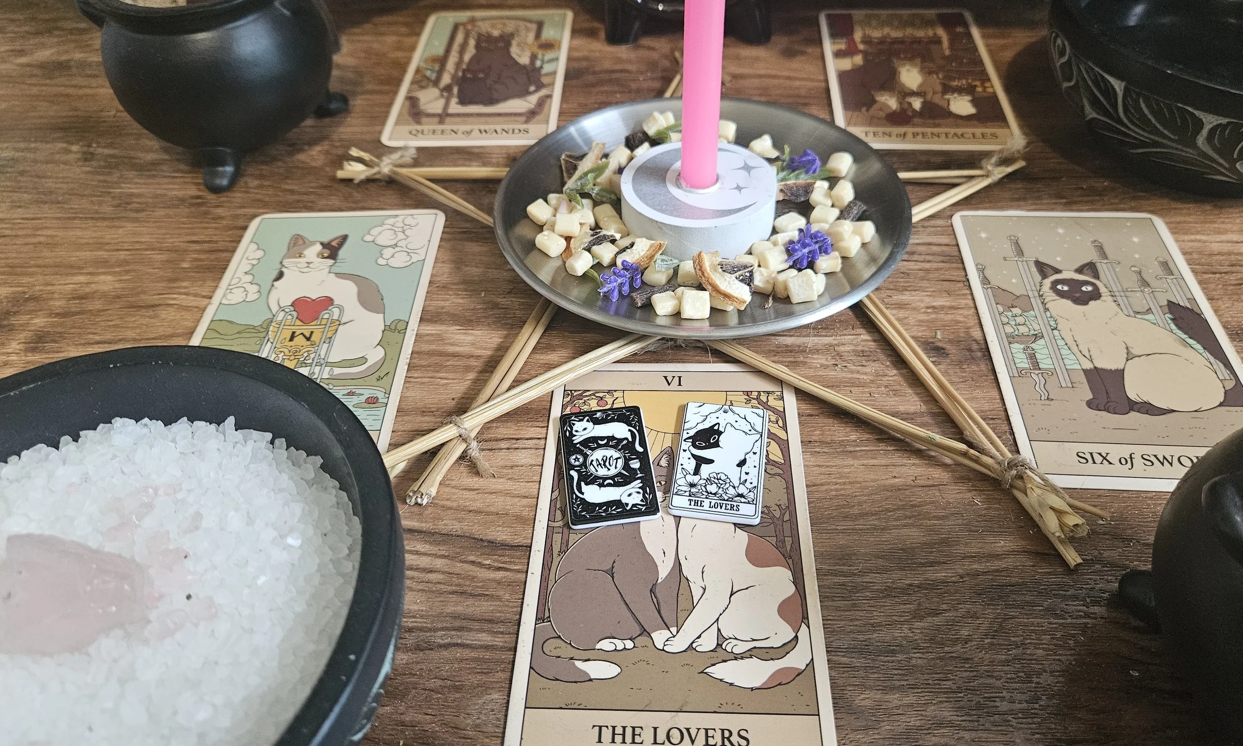 A tabletop set with tarot cards laid out and a glowing candle, suggesting a tarot reading session.