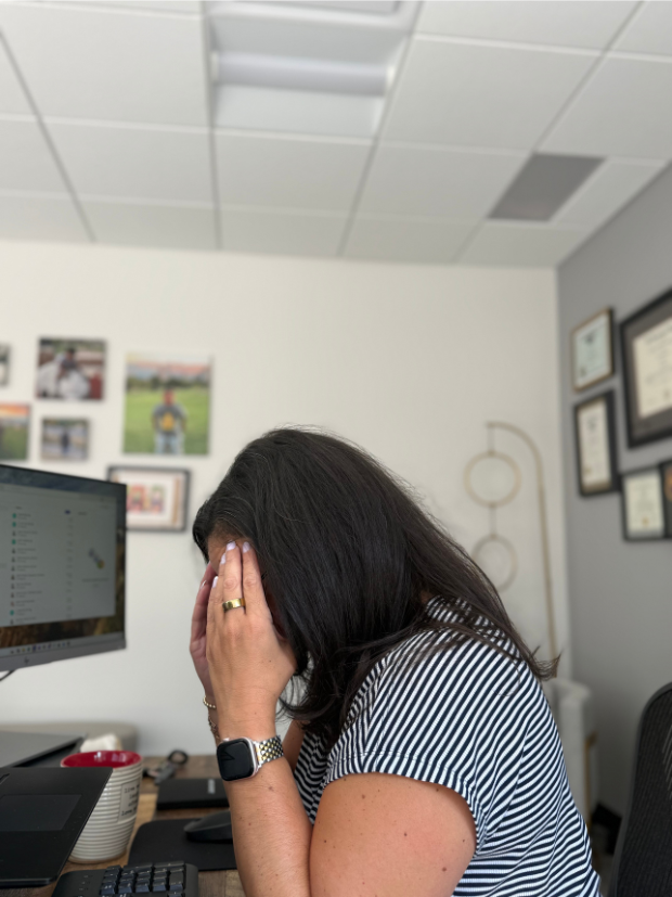 High-achieving attorney experiencing mental fatigue and stress at her desk, illustrating how poor recovery can impact energy, focus, and daily performance.