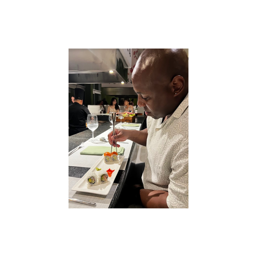 Man eating a healthy sushi meal at a restaurant, illustrating how making nutritious food choices can support stress management and overall health.