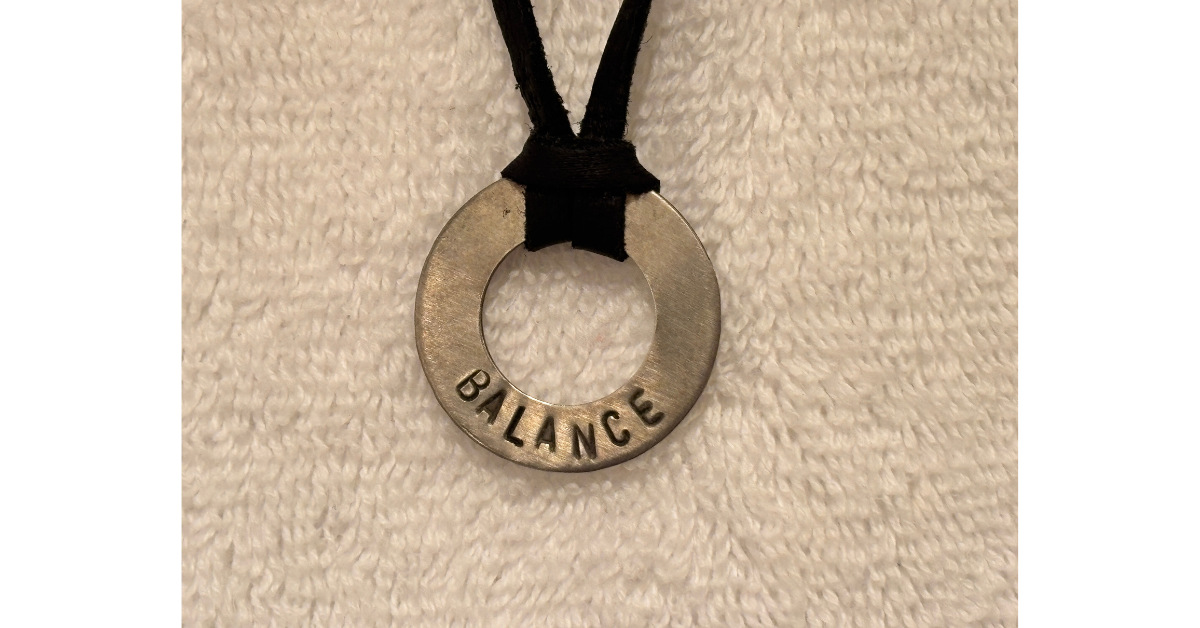 Pendant engraved with the word BALANCE