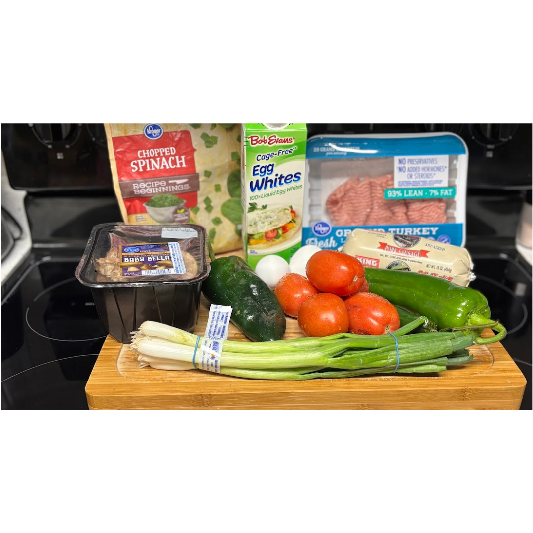 High-protein breakfast casserole meal prep ingredients including egg whites, 93% lean ground turkey, chopped spinach, baby bella mushrooms, tomatoes, jalapeenos, and green onions — performance breakfast prep for busy professionals