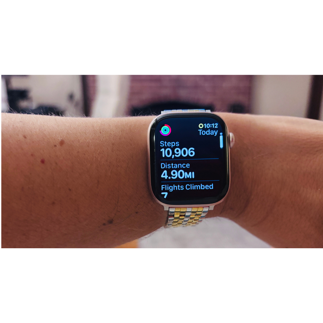 Apple Watch displaying 10,906 steps, 4.90 miles, and 7 flights climbed for today's activity tracking