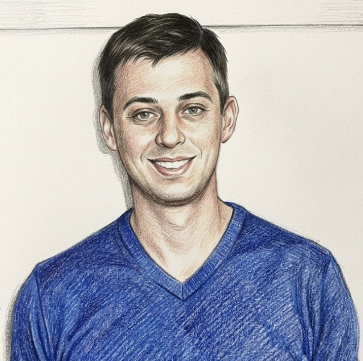 A woman with curly hair and glasses smiling indoors.