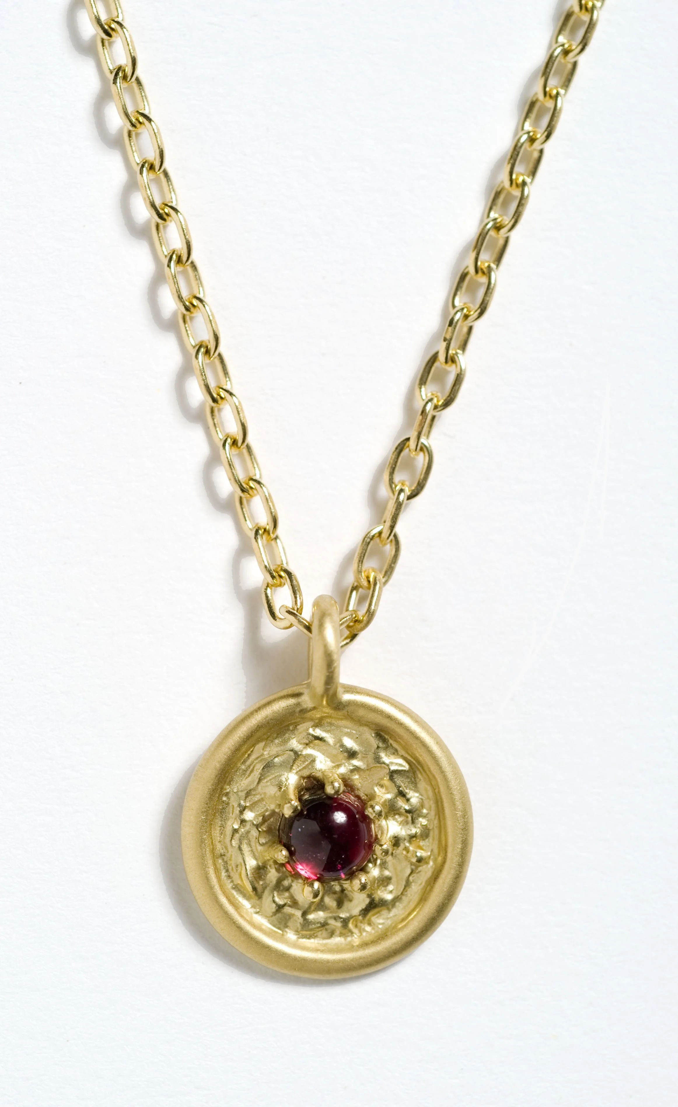  Adriana 
 Framed cabochon with a zodiac sign carved on back of pendant. Can be custom made with the birthstone and sign of the wearer, RSN03