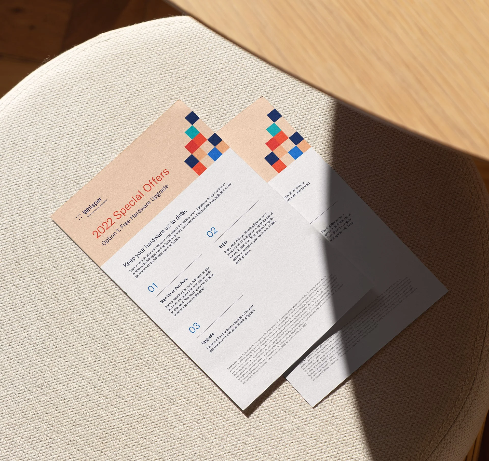 Flyers placed on a stool, promoting new pricing for a hearing aid brand.