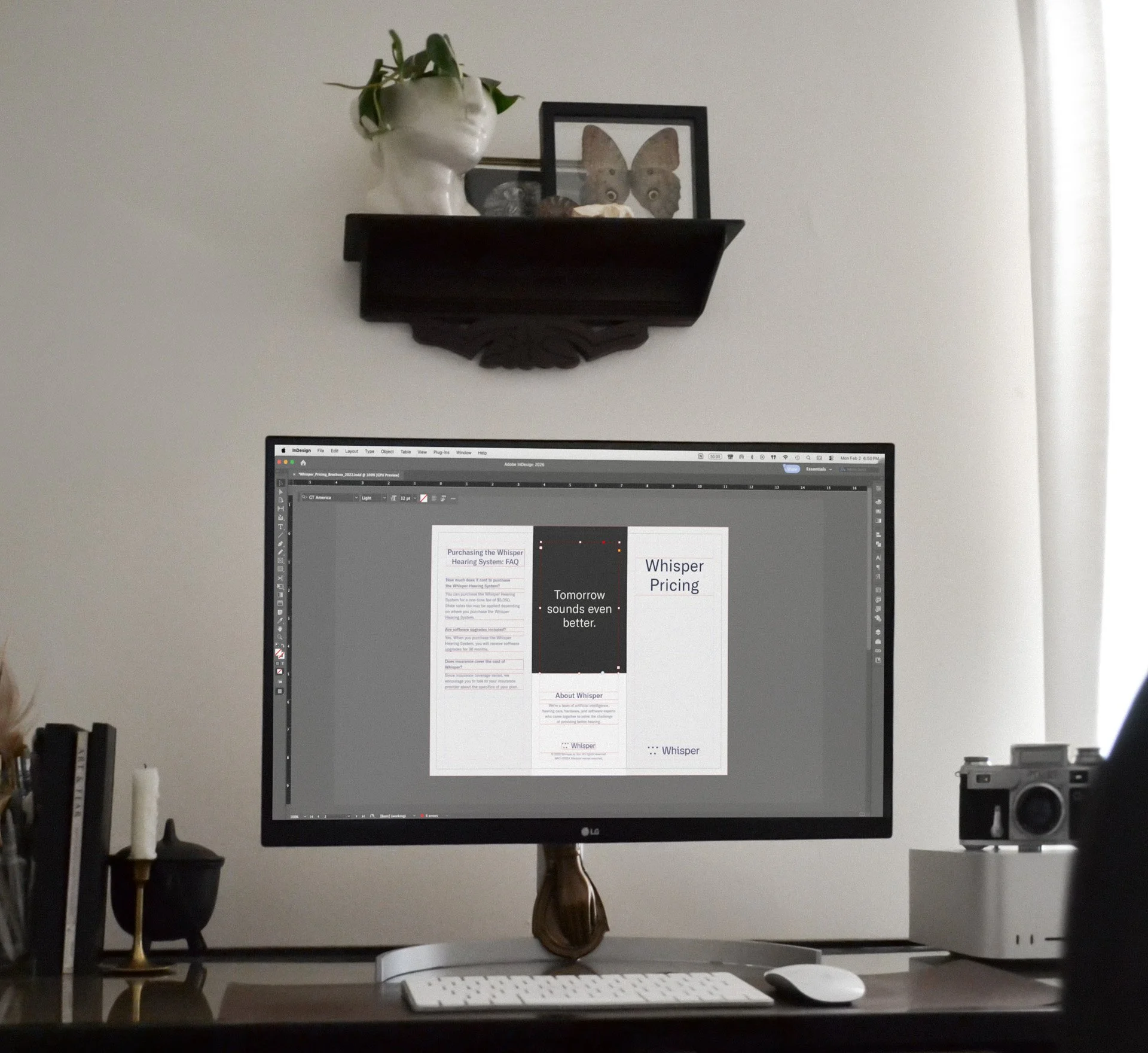 Desk with computer showing a design project in progress.